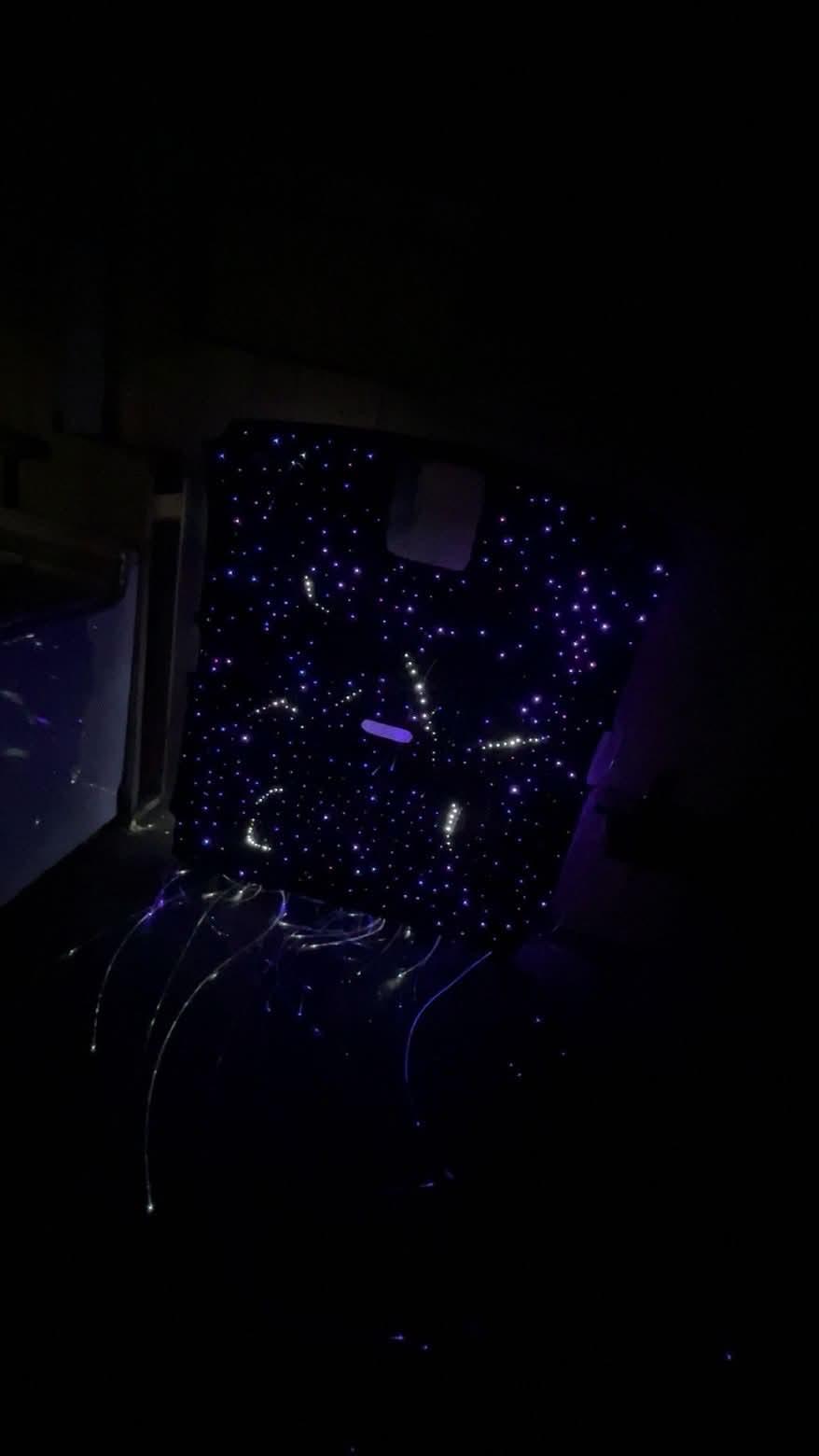 Strand tails cascading from behind a lit starlight panel